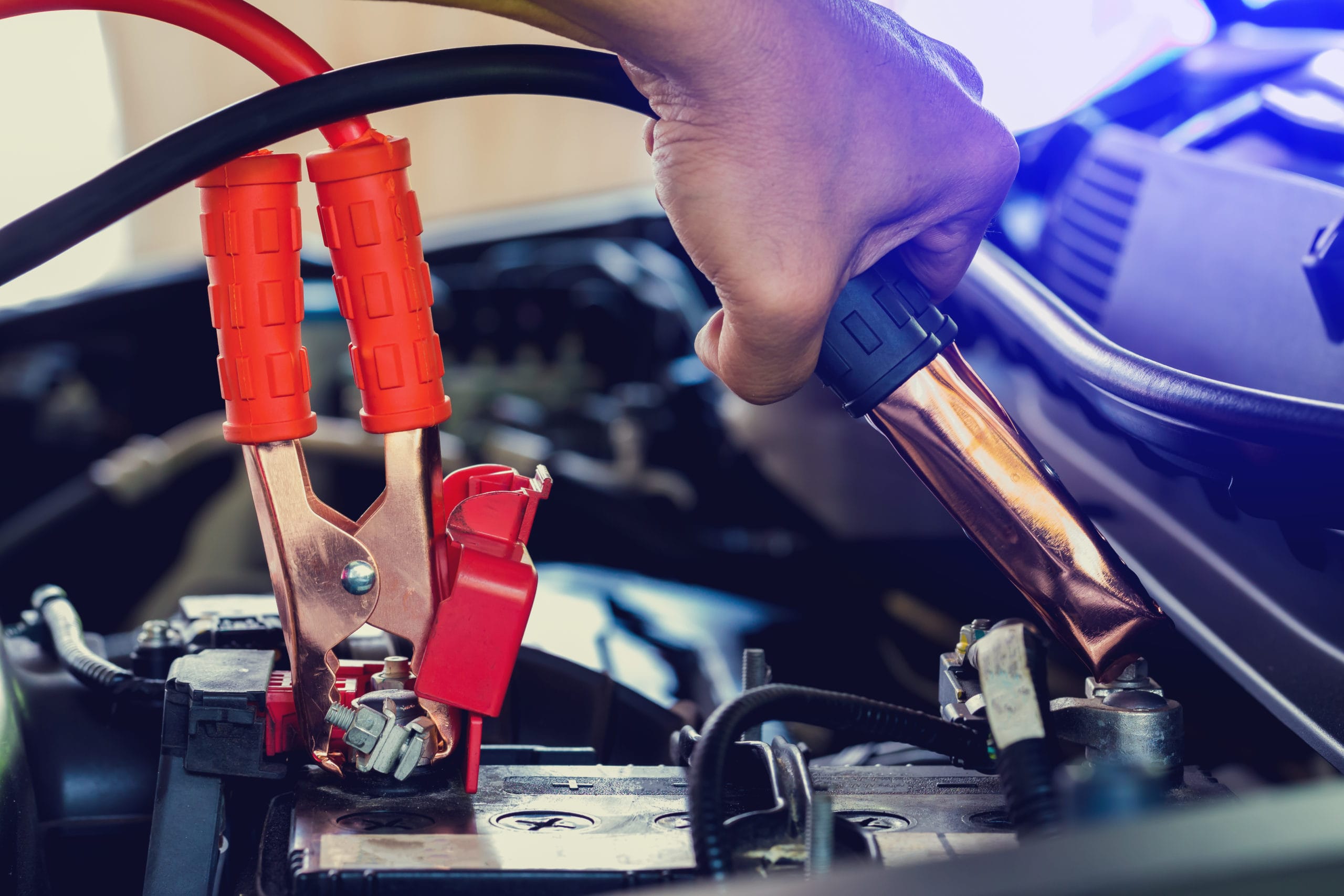 Close-up of jump starting a car battery.
