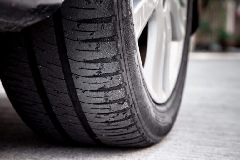 Car tire with signs of wear in need of replacement