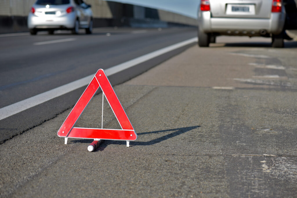 Closeup of a persons hands pulling an emergency brake on a non descript car