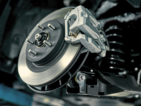 Close up of a car brake caliper, exposed during Telle Tire's brake repair services.