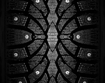 Closeup of the tread on a studded winter tire.