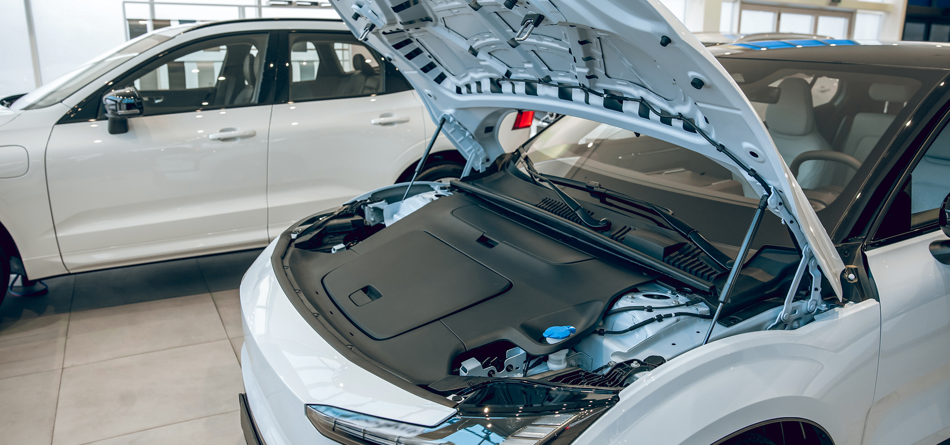 An electric vehicle with its hood up, awaiting service at a Telle Tire & Auto Centers location.