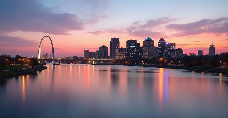 The St. Louis city skyline at dusk, looking down river from the north toward the Gateway Arch.