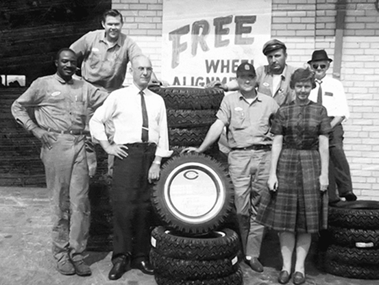 The First Generation owners, Froesel-Telle standing out front of the shop with mechanic team.