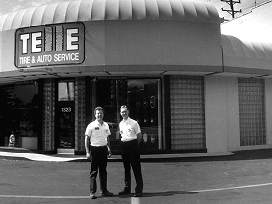Second-generation owner, Chuck Telle, and partner standing in front of the Telle Tire location.