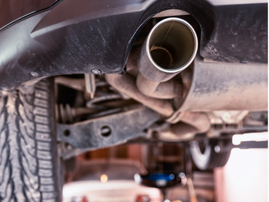 Close up of a vehicle's exhaust pipe, a vital part of the MO Inspection & Emissions Testing performed by Telle Tire.
