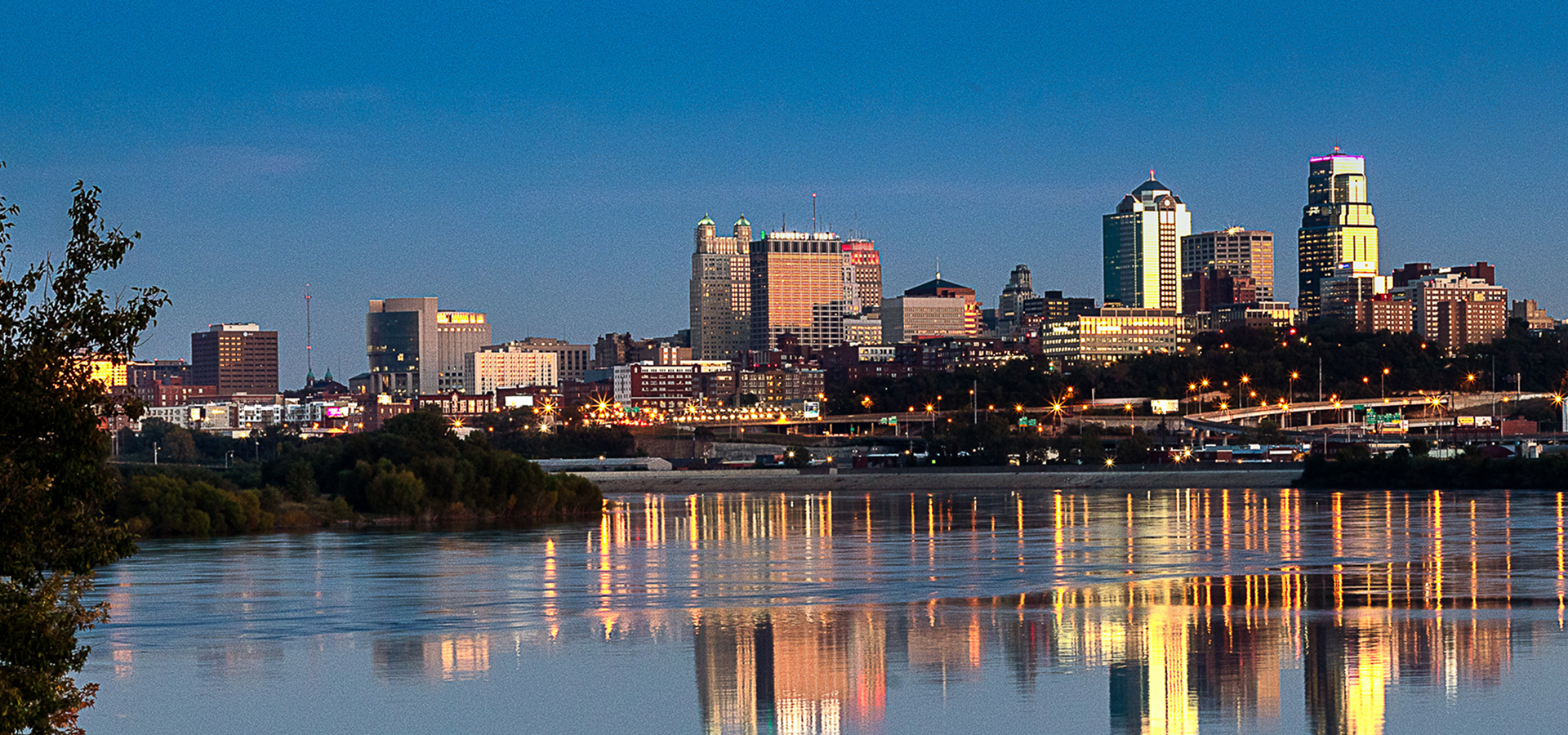 The Kansas City skyline at dusk as seen from across the river.
