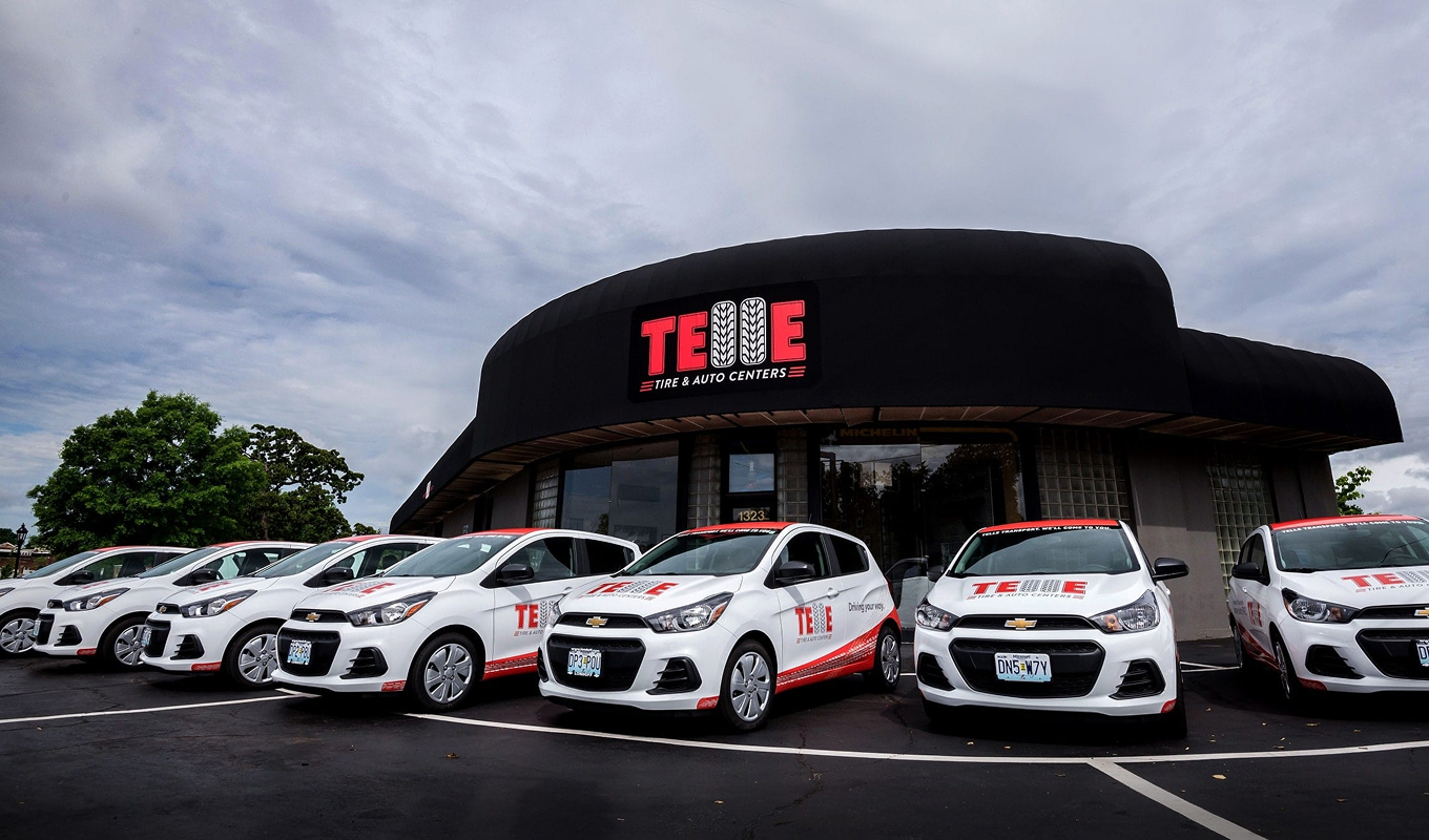 A front view of the Telle Tire & Auto Centers Richmond Heights, MO, location with Telle branded vehicles parked out front.