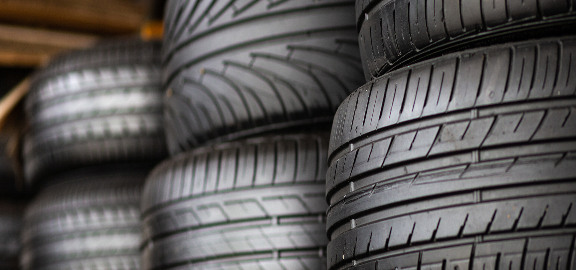 Closeup of several stacks of brand new tires.