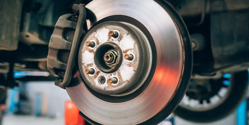The disc brake assembly of a vehicle, specifically highlighting the brake rotor and caliper.